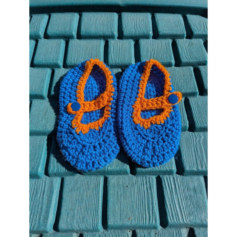 Orange and blue crocheted slippers with button closure. Brand new, super soft